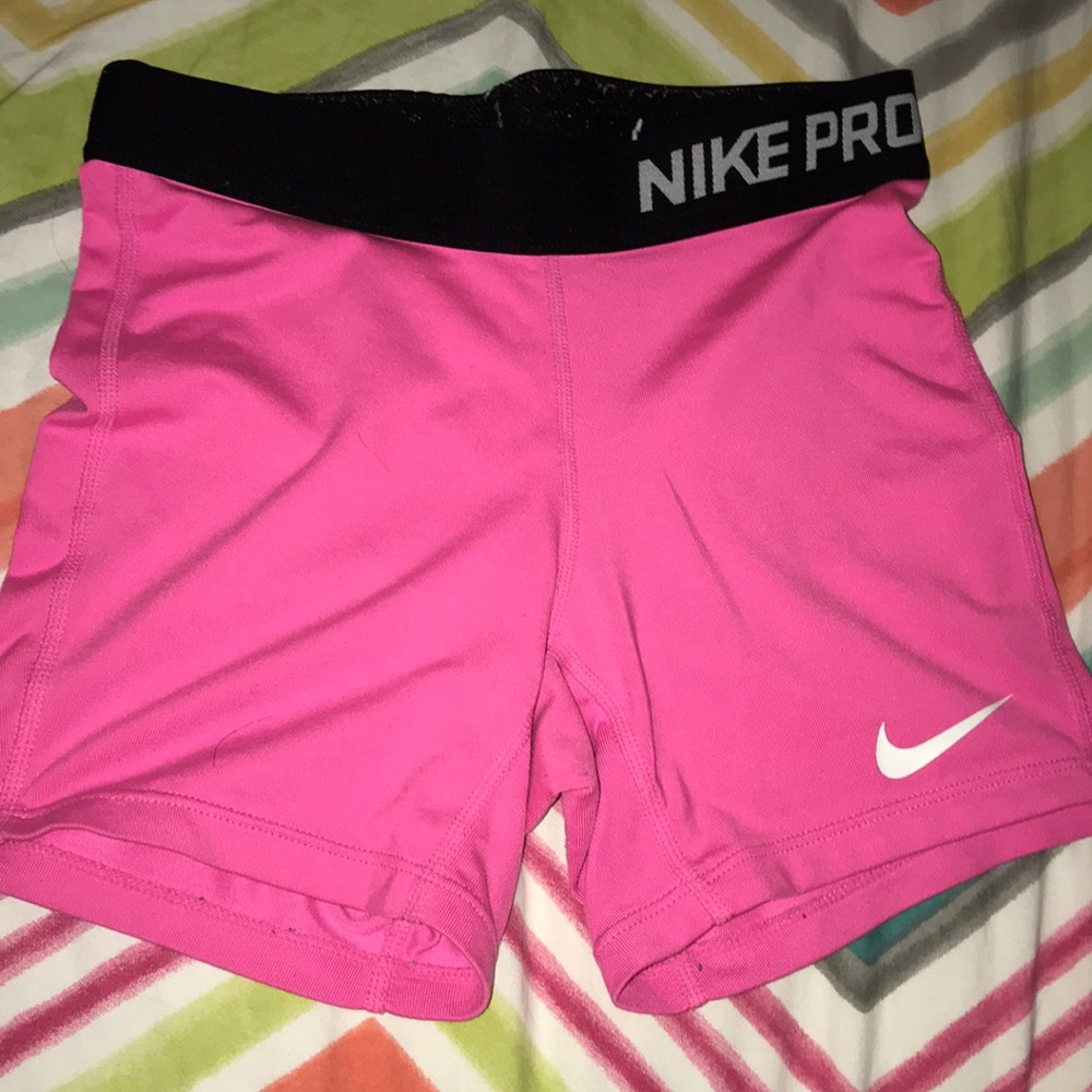 Hot pink nike pro spandex, black band.